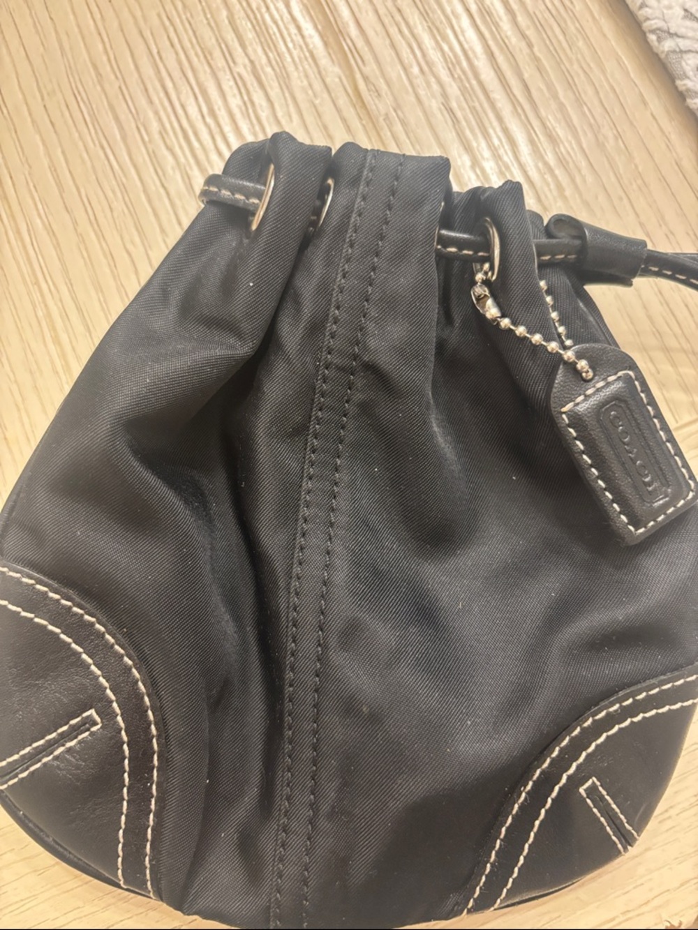 Coach Black Nylon wristlet with White Stitching and black leather trim.